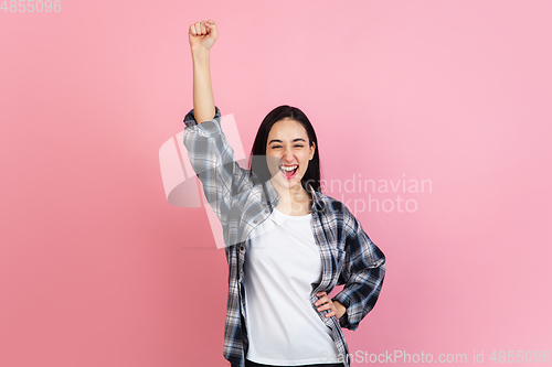Image of Caucasian woman\'s portrait isolated on coral pink studio background with copyspace