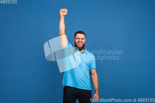 Image of Caucasian man\'s portrait isolated on blue studio background with copyspace