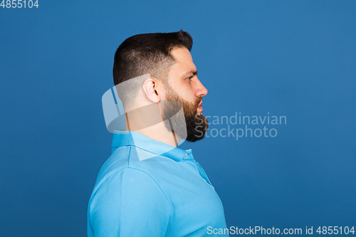 Image of Caucasian man\'s portrait isolated on blue studio background with copyspace