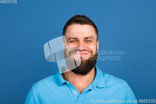 Image of Caucasian man\'s portrait isolated on blue studio background with copyspace