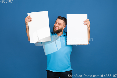 Image of Caucasian man\'s portrait isolated on blue studio background with copyspace