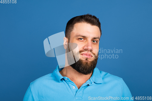 Image of Caucasian man\'s portrait isolated on blue studio background with copyspace