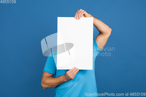Image of Caucasian man\'s portrait isolated on blue studio background with copyspace