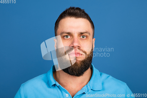 Image of Caucasian man\'s portrait isolated on blue studio background with copyspace