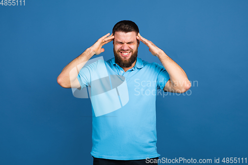 Image of Caucasian man\'s portrait isolated on blue studio background with copyspace