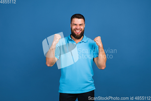 Image of Caucasian man\'s portrait isolated on blue studio background with copyspace