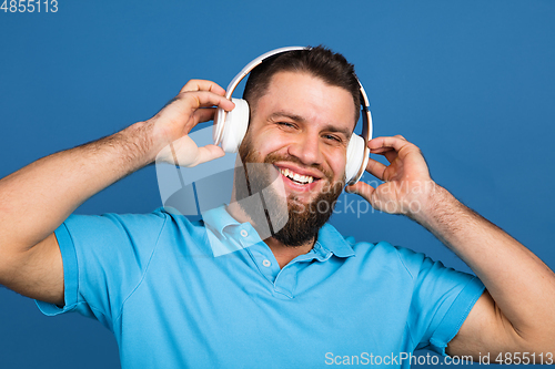 Image of Caucasian man\'s portrait isolated on blue studio background with copyspace