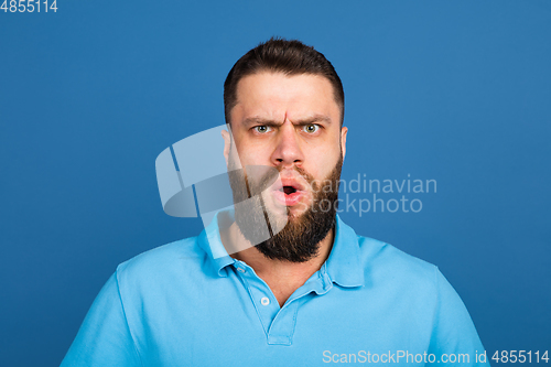 Image of Caucasian man\'s portrait isolated on blue studio background with copyspace