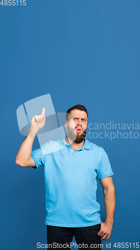 Image of Caucasian man\'s portrait isolated on blue studio background with copyspace