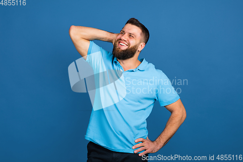 Image of Caucasian man\'s portrait isolated on blue studio background with copyspace