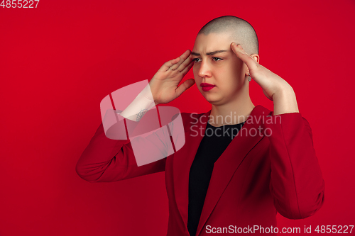Image of Portrait of young caucasian bald woman on red background
