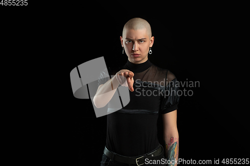 Image of Monochrome portrait of young caucasian bald woman on black background