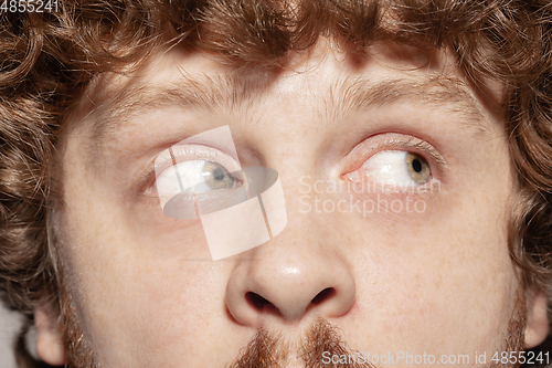 Image of Close up of face of beautiful caucasian young man, focus on eyes