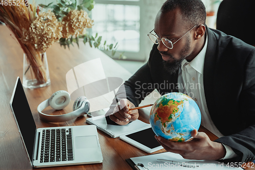 Image of Businessman or student working from home while being isolated or keep quarantine \'cause of coronavirus COVID-19