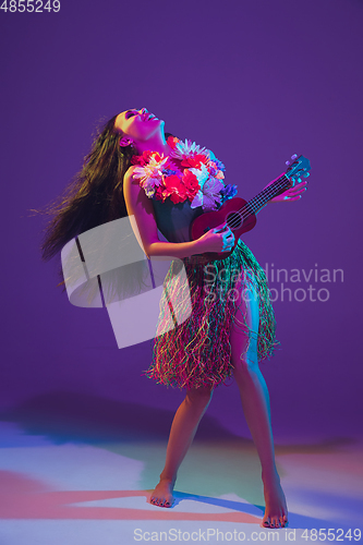 Image of Fabulous Cinco de Mayo female dancer on purple studio background in neon light