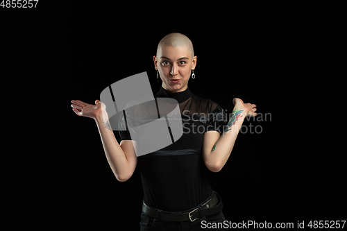 Image of Monochrome portrait of young caucasian bald woman on black background