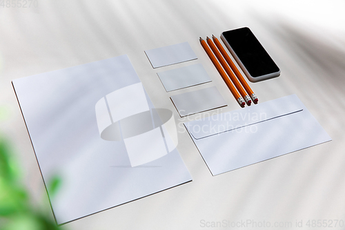 Image of Creative and cozy workplace at home office, inspirational mock up with plant shadows on table surface