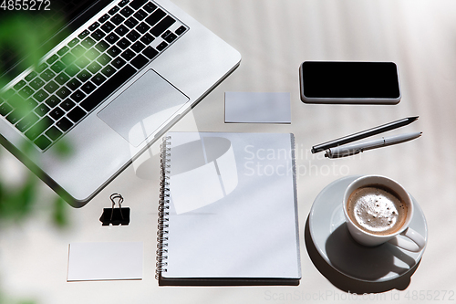 Image of Creative and cozy workplace at home office, inspirational mock up with plant shadows on table surface