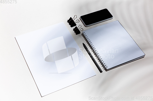 Image of Creative and cozy workplace at home office, inspirational mock up with plant shadows on table surface