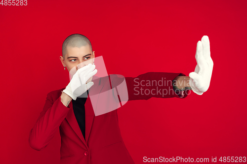 Image of Portrait of young caucasian bald woman on red background