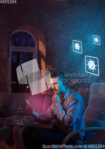 Image of Shocked, upset and sad man using gadgets to get information of coronavirus pandemic spread