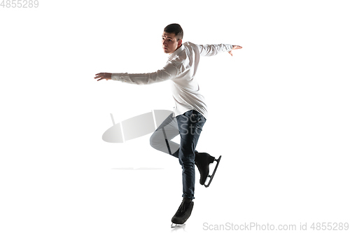 Image of Man figure skating isolated on white studio backgound with copyspace