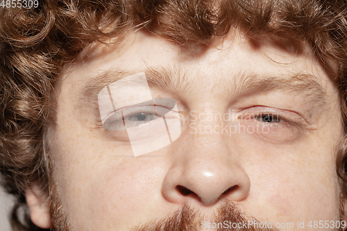 Image of Close up of face of beautiful caucasian young man, focus on eyes