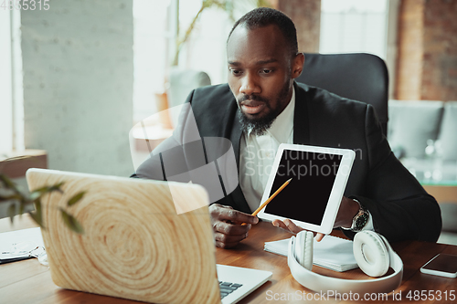 Image of Businessman or student working from home while being isolated or keep quarantine \'cause of coronavirus COVID-19