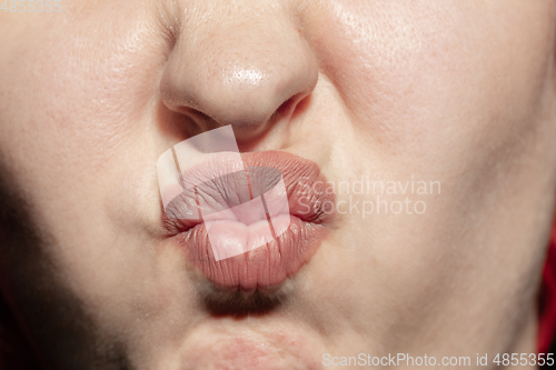 Image of Close-up female mouth with natural lips make-up. Cosmetology, dentistry and beauty care, human emotions