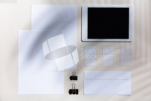 Image of Creative and cozy workplace at home office, inspirational mock up with plant shadows on table surface