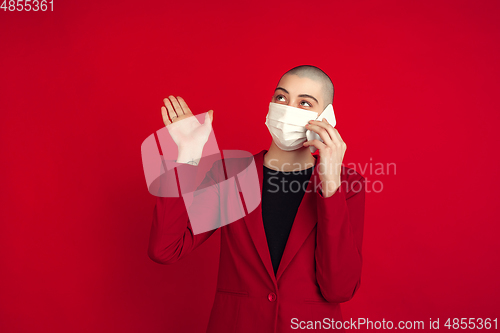 Image of Portrait of young caucasian bald woman on red background