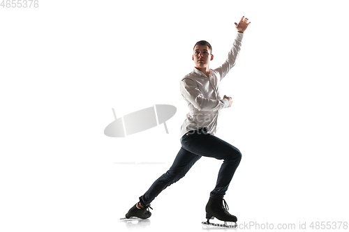 Image of Man figure skating isolated on white studio backgound with copyspace