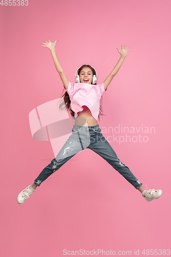 Image of Caucasian little girl portrait isolated on pink studio background, emotions concept