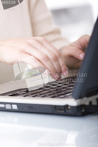 Image of typing on a laptop