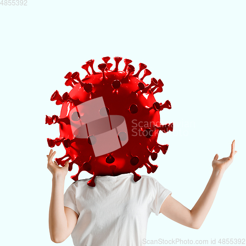 Image of Woman headed by model of COVID-19 coronavirus, concept of pandemic spreading