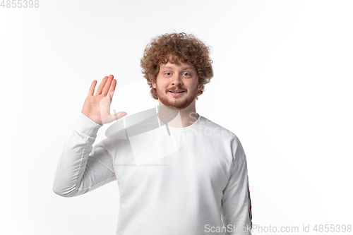 Image of How coronavirus changed our lives. Young man greeting on white background