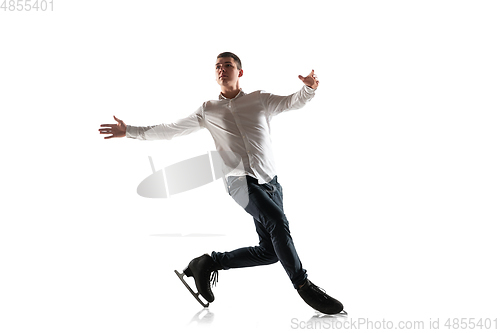 Image of Man figure skating isolated on white studio backgound with copyspace