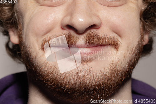 Image of Close-up male mouth illustrating emotions. Cosmetology, dentistry and beauty care, facial expression