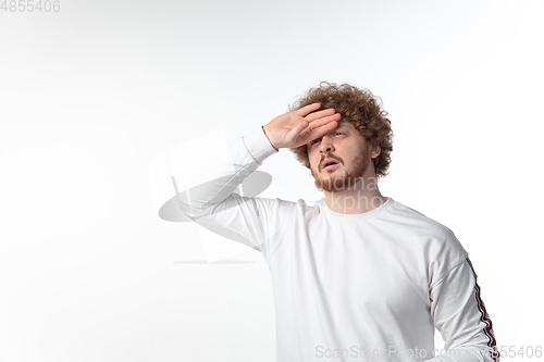 Image of How coronavirus changed our lives. Young man taking temperature on white background