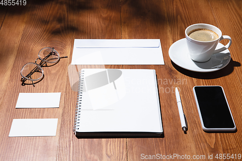 Image of Creative and cozy workplace at home office, inspirational mock up with plant shadows on table surface