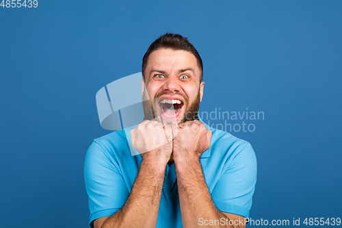 Image of Caucasian man\'s portrait isolated on blue studio background with copyspace
