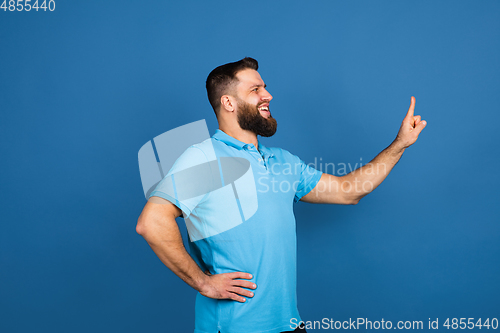 Image of Caucasian man\'s portrait isolated on blue studio background with copyspace
