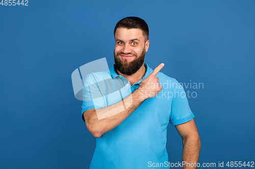 Image of Caucasian man\'s portrait isolated on blue studio background with copyspace