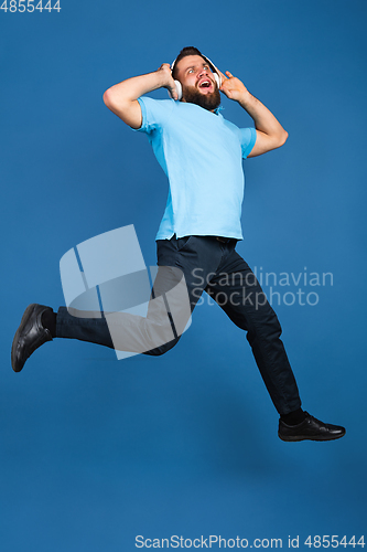 Image of Caucasian man\'s portrait isolated on blue studio background with copyspace