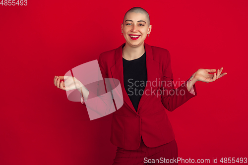 Image of Portrait of young caucasian bald woman on red background