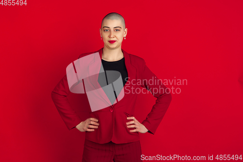 Image of Portrait of young caucasian bald woman on red background