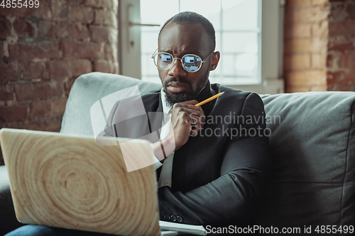 Image of Businessman or student working from home while being isolated or keep quarantine \'cause of coronavirus COVID-19