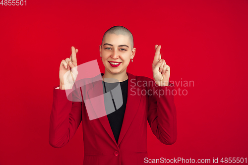 Image of Portrait of young caucasian bald woman on red background