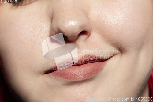 Image of Close-up female mouth with natural lips make-up. Cosmetology, dentistry and beauty care, human emotions