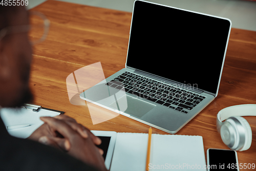 Image of Top view of businessman or student working from home while being isolated or keep quarantine \'cause of coronavirus COVID-19